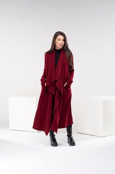 "Stay warm while staying fashionable with this wool asymmetrical cloak. Extravagant and loose, it features side pockets and thumb holes. The model in the picture is 170cm. ⅼ 5.7 ft. tall and is wearing size XS/color: burgundy  🌟 INFO: * Worldwide EXPRESS shipping - please provide a phone number for shipping documents * US Sizing XS to 4XL - size chart available below - all measurements of the body 🌟 MATERIAL & CARE * fabric: acrylic wool cotton mix * hand wash * cold water 30 degrees * Iron at Red Winter Cardigan For Layering, Chic Red Long Sleeve Cardigan, Elegant Red Cardigan For Fall, Red Open Front Winter Sweater, Red Sweater Coat For Fall Layering, Red Open Front Sweater For Winter, Asymmetrical Sweater For Winter, Winter Wrap Sweater For Work, Winter Wrap Sweater For Workwear