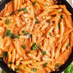 a skillet filled with pasta and parmesan cheese