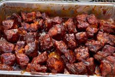 a pan filled with meat sitting on top of a table