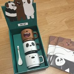 two coffee mugs in a box with panda and panda stickers on the side