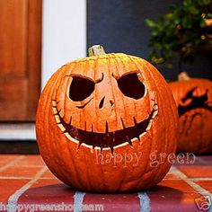 two carved pumpkins sitting on the front porch with their faces cut out to look like jack - o'- lanterns