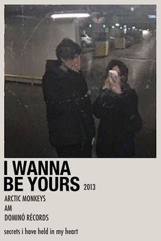 two people standing next to each other in front of a sign that says i wanna be yours arctic monkeys