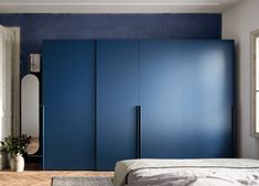 a bedroom with blue walls and wooden floors