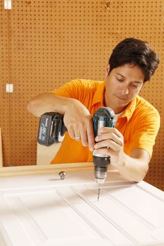 a man using a driller on a piece of wood