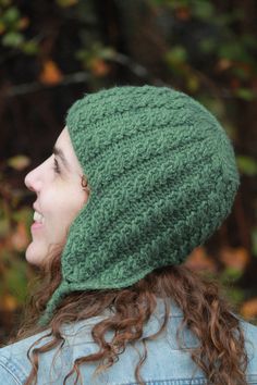 a woman wearing a green knitted hat