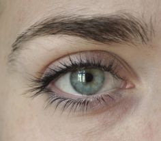 a close up view of an eye with long lashes