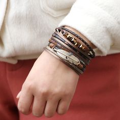 Multi-strand PU leather bracelet. Great quality! Connects with a plated bar that is magnetic. We really love this bright but deep brown imitation leather. The variety of colors and textures in this bracelet make it a perfect match for a wide range of outfits. We are positive you'll love this bracelet! We also have it available in buckskin and gray. Trendy Brown Bracelet As Fashion Accessory, Trendy Brown Bracelets As Fashion Accessory, Trendy Brown Wrap Bracelet Gift, Trendy Brown Leather Bracelet, Elegant Brown Leather Wrap Bracelet, Bohemian Wrap, Leather Bangle, Boho Feathers, Gold Feathers