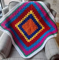 a crocheted blanket sitting on top of a chair