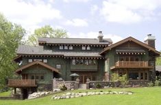 a large house with lots of windows on the front and side of it's roof