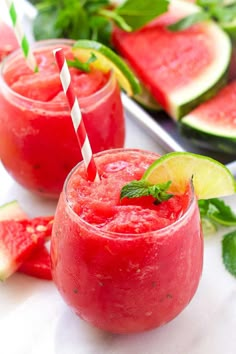 watermelon slushies in glasses with limes and mint on the side