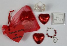 the contents of a valentine's day gift bag are laid out on a white surface