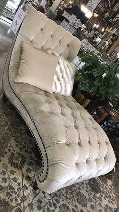 a white chaise lounge chair sitting on top of a rug