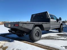 the truck is parked on the side of the road covered in snow and ice,