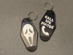 two key chains with the words call me maybe and a ghost face painted on them