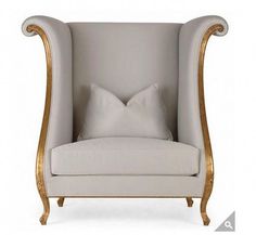 a white chair with gold trimming and a pillow on top of the armrest