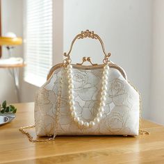 44224562888920 Elegant White Satchel For Party, Formal Gold Box Bag With Large Capacity, Feminine Beige Wedding Bags, Elegant Gold Satchel For Party, Cream Party Shoulder Bag, Elegant Large Capacity Evening Bag, Cream Clutch Bag For Party, Cream Shoulder Bag For Party, Vintage Evening Shoulder Bag With Large Capacity