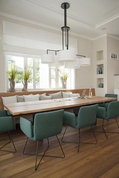 a dining room table with blue chairs around it