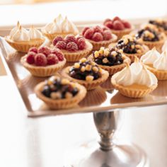 there are many small desserts on the tray