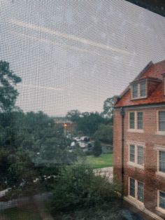 the view from inside an apartment building through a screen