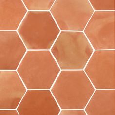 an orange and white tiled floor with hexagonal tiles