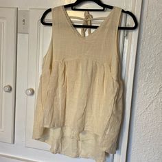 Boutique Tank Blouse. Cream In Color With Lace Detail Around The V Neck. Ties In The Back. Never Worn Summer Beige Tops For Daytime, Beige Tops For Daytime Summer, Beige Tops For Daytime Summer Wear, Beige Bohemian Sleeveless Blouse, Beige Sleeveless Top For Daytime, Spring Bohemian Tank Top For Daywear, Bohemian Spring Tank Top For Daywear, Bohemian Tank Top For Spring Daywear, Beige Sleeveless Blouse For Beach