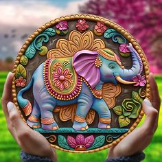 an elephant painted on a plate in front of a green field with trees and flowers