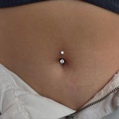 a woman's stomach with a tiny white diamond on it, and the bottom part of her belly is visible