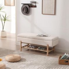 a living room with white walls and wooden flooring, two baskets on the floor