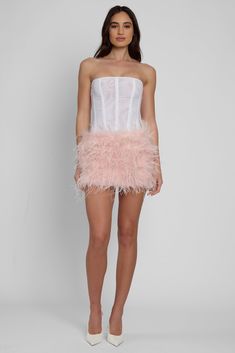 A true wardrobe icon - take your glam to the next level with our Cloud Feather Mini Skirt. Made from delicate white feathers, it features a comfortable interior lining and a flattering mini length in our signature LEAU mini skirt cut. Elevate any outfit with this must-have piece in your wardrobe. Pink feather mini skirt 100% ostrich feather with non-stretch interior lining Back zipper for easy slip on access Chic Mini Skirt With Feather Trim For Party, Chic Feather Trim Skirt For Spring, Chic Party Mini Skirt With Feather Trim, Chic Skirt With Feather Trim For Spring, Summer Night Out Skirt With Feather Trim, Summer Feather Trim Skirt For Night Out, Chic Summer Skirt With Feather Trim, Chic Feathered Bottoms For Summer, Chic Summer Bottoms With Feathers