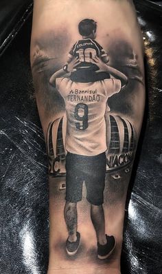 a man's foot with a tattoo on it that has a football player holding a ball