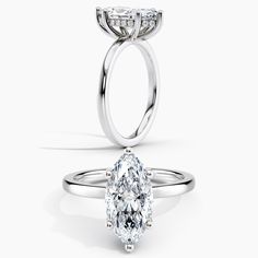 a pear shaped diamond engagement ring on a white background