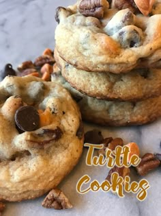 three cookies stacked on top of each other with chocolate chips and walnuts in the middle