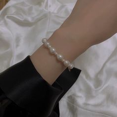 This is a delicate and natural freshwater pearl bracelet that features a beaded design and a magnetic clasp for easy wear. It is a perfect bracelet for women looking for a simple and elegant accessory to add to their daily outfits. The bracelet is made with high-quality materials and is a great choice for a gift for someone special. 👌 M A T E R I A L • Natural freshwater pearls• This product is hypoallergenic (nickel free) and tarnish resistant 📏 S I Z E • Natural pearl diamete with diameter: Classic Pearl Charm Bangle Bracelet, Feminine Pearl Bracelets With Pearl Charm, Pearl White Bangle Pearl Bracelet, Pearl White Pearl Bangle Bracelet, Elegant Pearl Bracelets For Everyday, Pearl Charm Beaded Bangle Bracelet, Pearl Chain Bracelets, Pearl Bangle With Pearl Charm, Delicate Pearl Bracelet With Round Beads