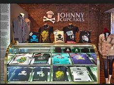 mannequins and t - shirts are on display at the johnny cupcakes store