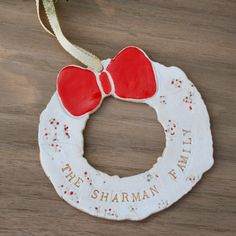 a ceramic ornament with a red bow on it