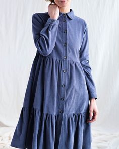 "Flowy needlecord front-button shirtdress punctuated with flouncy tiered ruffles. - Handmade in our studio from 100% cotton - Loose A-line silhouette - Shirt collar - Button placket through - Long sleeves with cuff and button - Side seam pockets - Knee length FABRIC&CARE The dress is made from 100% cotton fabric. Hand wash or gently machine washable 30C, hang dry recommended, iron on reverse. SIZE&FIT Simona is wearing denim blue dress in size S and is 172 cm/5'8″ tall. SIZE XXS *BODY: B Cotton Ruffled Button-up Shirt Dress, Cotton Button-up Shirt Dress With Ruffles, Fall Ruffle Button-up Shirt Dress, Fall Ruffled Button-up Shirt Dress, Fall Button-up Shirt Dress With Ruffles, Kinds Of Fabric, Feminine Look, Tiered Dress, I Dress