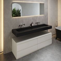 a bathroom with two sinks and a bathtub next to it in front of a mirror