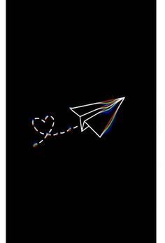 a white paper airplane flying through the dark sky with colored lines coming out of it