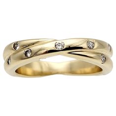 a yellow gold wedding ring with three diamonds