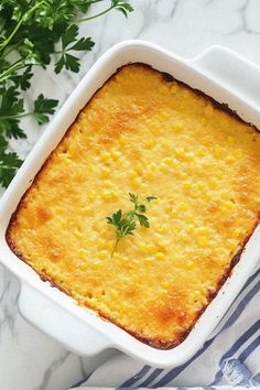 a casserole dish with corn and parsley