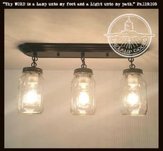 three mason jar lights hanging from the ceiling