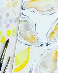 the watercolors are being used to paint an image of oysters and lemons