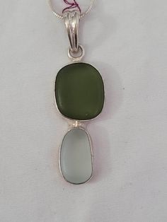 Capture the beauty of the Outer Banks with this authentic green and white sea glass pendant, elegantly set in sterling silver. Measuring 1/2 inch wide by 1 1/4 inches tall with the bale, this one-of-a-kind piece is perfect for sea glass lovers and those who treasure the ocean's gifts. Add a touch of coastal charm to your jewelry collection or gift it to someone special. I also do custom live edge furniture Message me for details Thanks for looking Please don't forget to check out my other items Green Rectangular Sterling Silver Jewelry, Green Recycled Glass Pendant Jewelry, Elegant Green Sea Glass Jewelry, Green Sterling Silver Rectangular Pendant, Green Sterling Silver Rectangular Pendant Jewelry, Green Sterling Silver Jewelry With Rectangular Pendant, Seafoam Sea Glass Jewelry For Gifts, Ocean Gifts, Ocean Inspired Jewelry