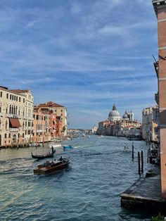 the boats are traveling down the canal in venice, italy on a clear sunny day