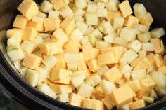 cubed cheese in a crock pot ready to be cooked