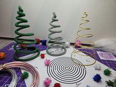 several different types of christmas ornaments on a purple table with white wall in the background