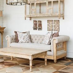 a living room with a couch and coffee table in front of a wall mounted shelf