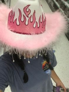 a person wearing a pink hat with flames on it