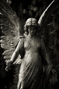 an angel statue is shown in black and white