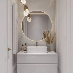 a bathroom with a round mirror above the sink